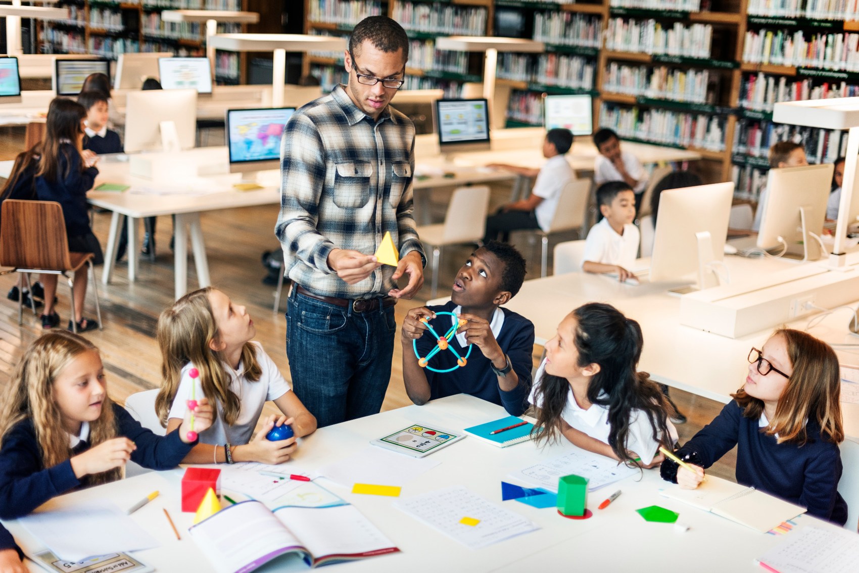 Teacher leading a group learning activity in a library