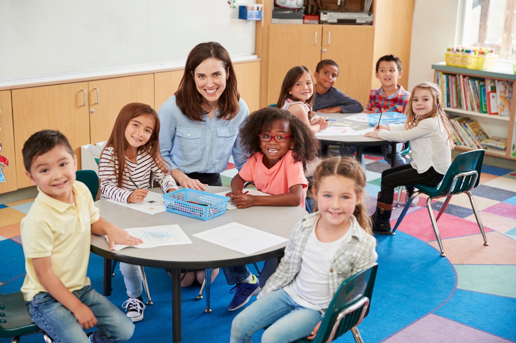 Teacher and pupils smiling together