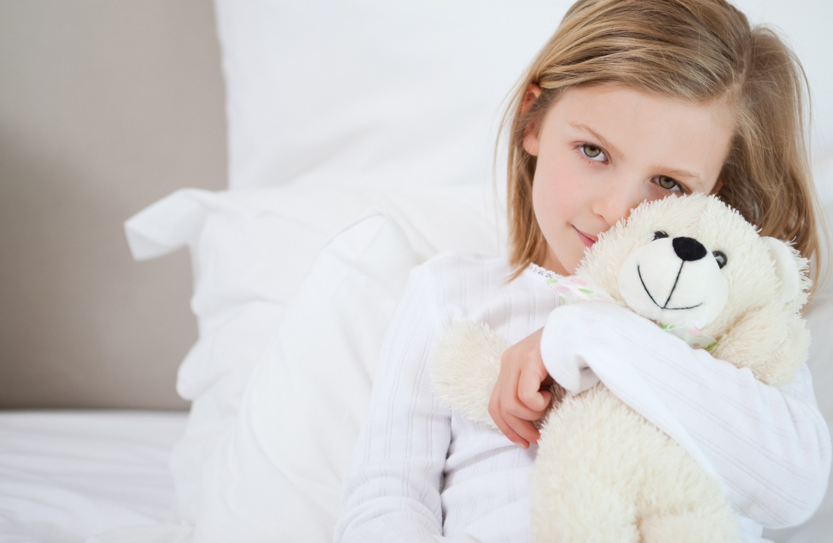 Child holding a soft toy close