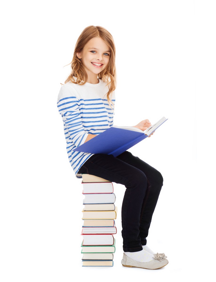 Child reading while sitting on a stack of books